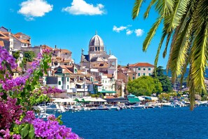 A coastal town with historic buildings, a prominent church with a dome, and a marina with boats. - S Villa With Pool, Jacuzzi & Gym (Vodice)