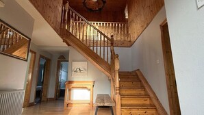 A wooden staircase with a handrail, a small bench, and a framed picture on the wall. - Skellig Cottage - Portmagee (Portmagee)