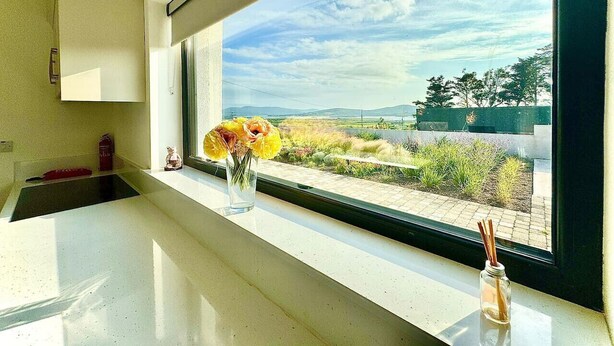 A kitchen with a window view of a landscaped area. - The Summit - Skellig Coast (Cahersiveen)