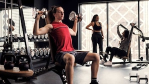 A gym with exercise equipment, a bench, and a mirrored wall. - Student Only White Rose View (Leeds)