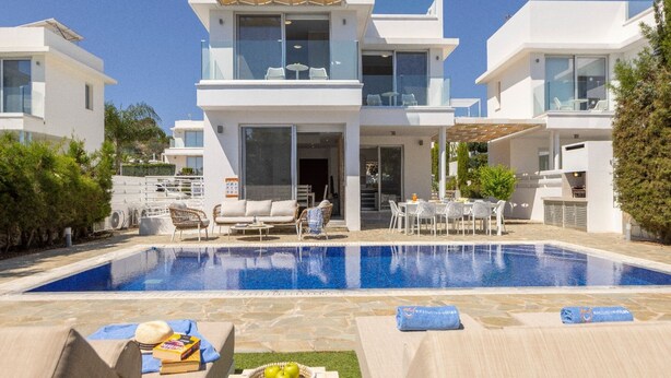 A modern villa with a swimming pool, outdoor seating, and a covered patio. - Milos lifestyle villas H9- 4 bedroom villa with private pool (Paralimni)