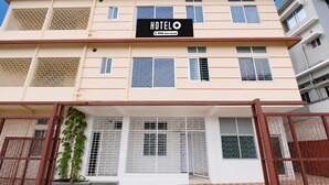 A multi-story hotel building with a sign reading 'HOTEL OYO Serviced'. - Classic Guwahati Stay Inn (Guwahati)