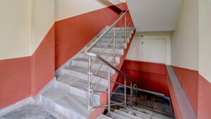A staircase with metal railings and marble steps leading to a door. - Classic Guwahati Stay Inn (Guwahati)