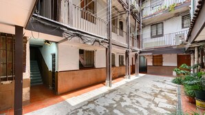 A multi-level building with balconies, a staircase, and a tiled courtyard. - (MDP80314) 1 bedroom apartment in the center of Madrid (Madrid)