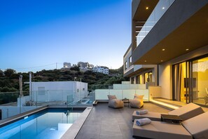 A rooftop pool area with a clear view of the cityscape, modern architecture, and a pool. - Maple Villa 2 Superior Sea View Villa, Walking Distance From Plakias Beach (Agios Vasileios)