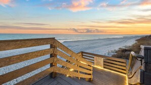 A wooden boardwalk leading to a beach with a sunset view. - Seagrove Sunrise 1004-Beachfront Views-Sleeps 6 (Seagrove Beach)