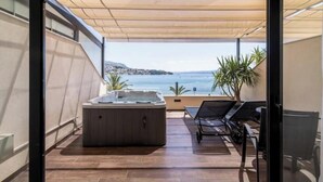 A balcony with a hot tub, lounge chairs, and a view of the sea. - Exclusive Room with Spa Bath, Seven of Nine (Stobreč)