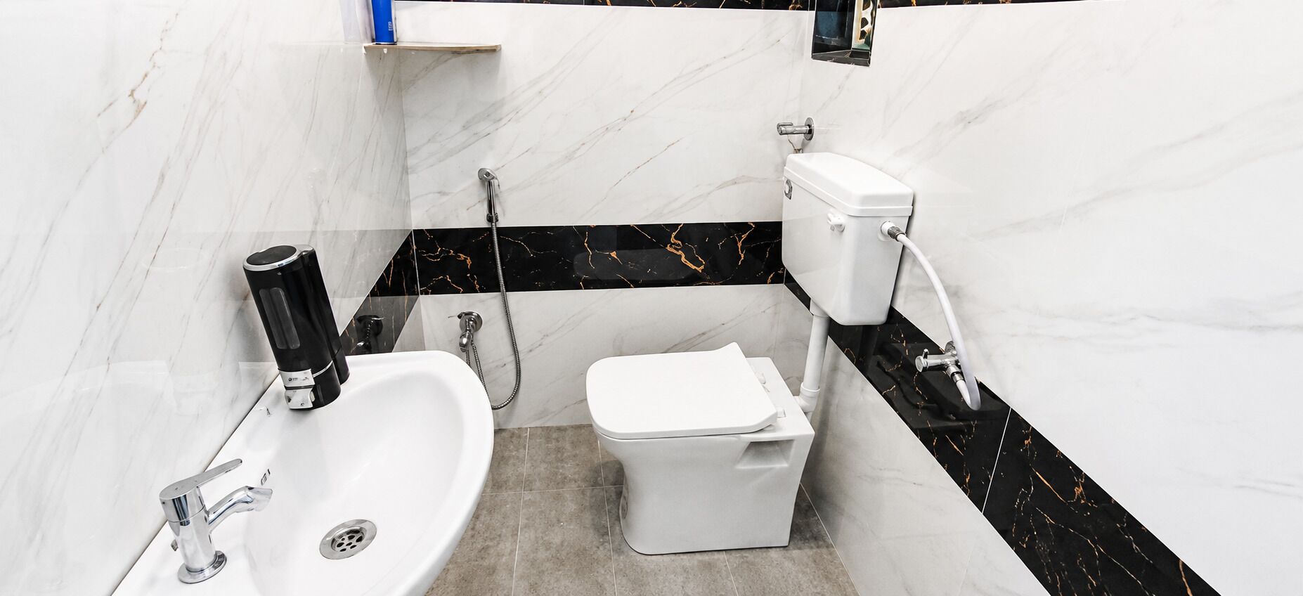 A bathroom with a white sink, toilet, and shower.