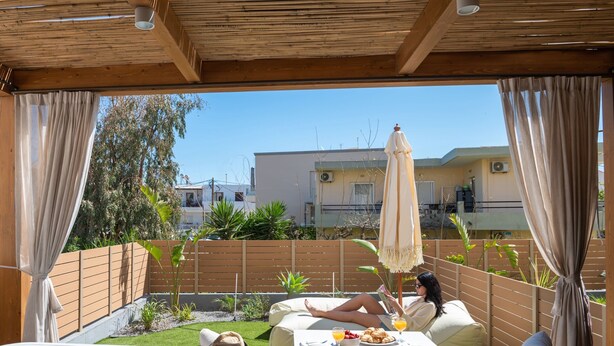 Um pátio com hidromassagem, área de estar externa e vista para edifícios.