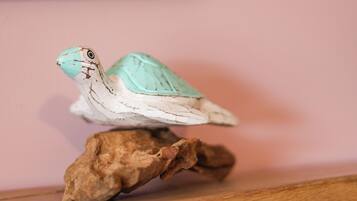 A small turtle figurine on a wooden base.