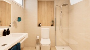 Ein modernes Badezimmer mit Toilette, Dusche und Waschbecken.