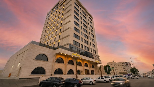 A hotel with a modern design, featuring a prominent entrance with arched windows and a sign. - Romantic Honeymoon Suite in Heart of Jeddah (Jeddah)