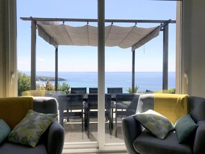 A balcony with a view of the sea, a pergola, and two sofas with cushions. - Panoramic Holiday Villa With Sea Views in Telgruc-sur-mer (Telgruc-sur-Mer)