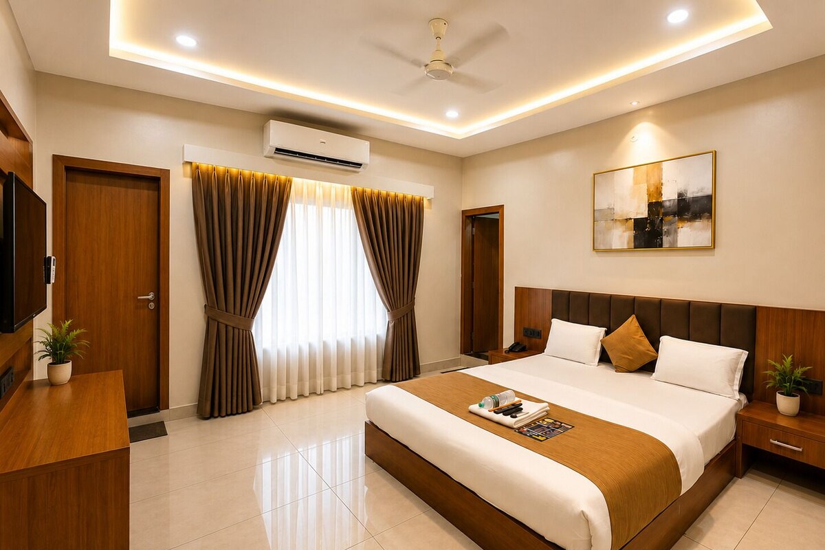 A modern hotel room with a large bed, bedside tables, a flat-screen TV, and a ceiling fan.