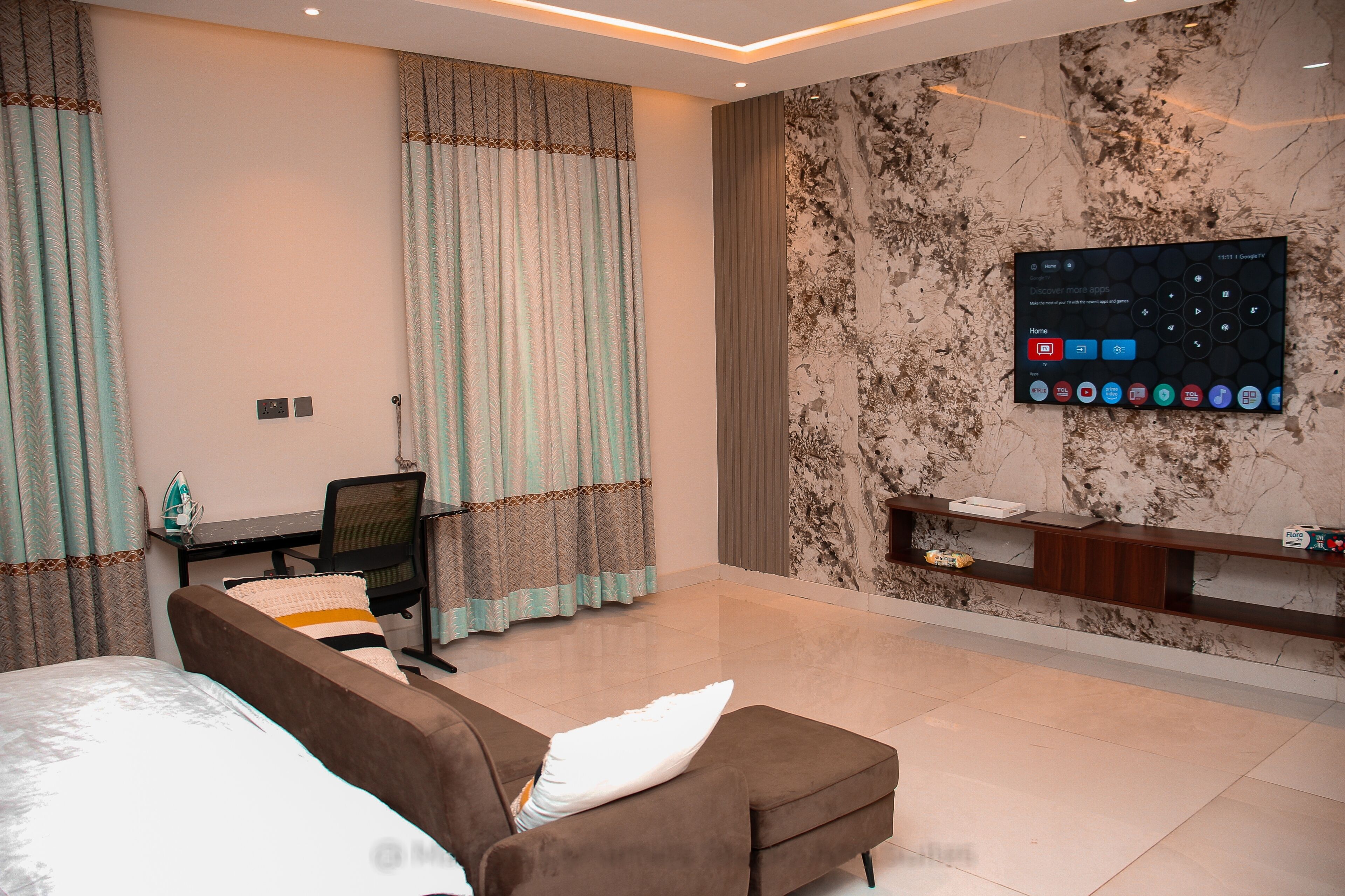 Deluxe Studio Suite | Living area | 70-inch Smart TV with digital channels, Netflix, streaming services