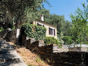 A stone house with a stone staircase leading up to it, surrounded by greenery. - Casetta Pantasina by Interhome (Pantasina)
