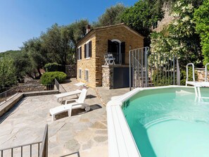 A stone building with a pool, outdoor seating, and a small bar area. - Casetta Pantasina by Interhome (Pantasina)