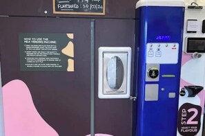 A milk vending machine with a step-by-step instruction sign and a flavor selection panel. - The Sailor's Galley (Aghada)