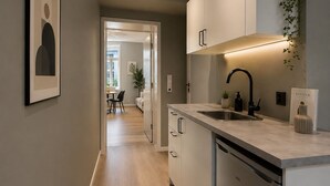 Een moderne keuken met een inbouw vaatwasser, een spoelbak en een aanrecht.