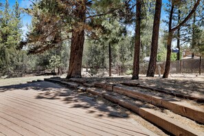 A wooden deck with steps leading into a forested area. - 4BR/3BA Big Bear Lake Retreat w/ Forest View (Big Bear Lake)