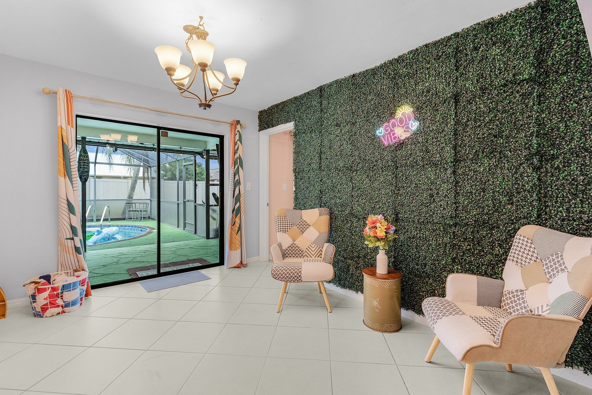 A modern interior with a pool view, a patterned armchair, and a green wall.