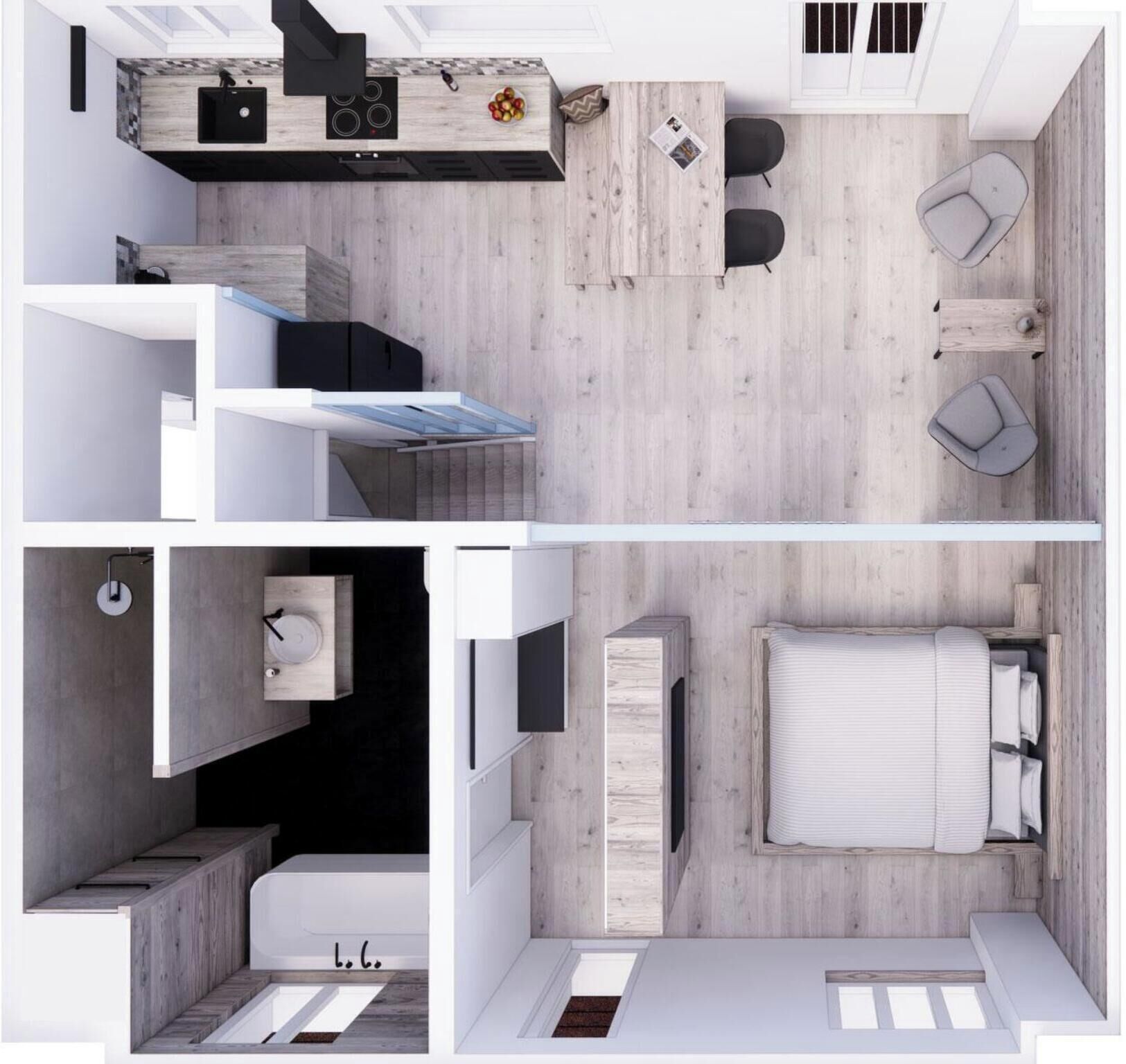 Un studio compact comprenant un coin cuisine, une petite salle de bain, un lit et un espace salon.