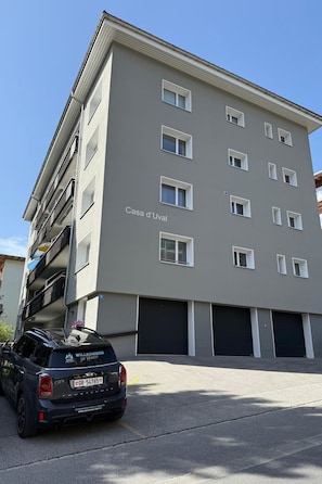 A multi-story building with a sign reading 'Casa d'Uval.' There are multiple windows and a black car parked in front. - Casa dUval by Arosa Holiday Appartement/Fewo, Dusche, WC, 6-Bettwohnung by Interhome (Arosa)