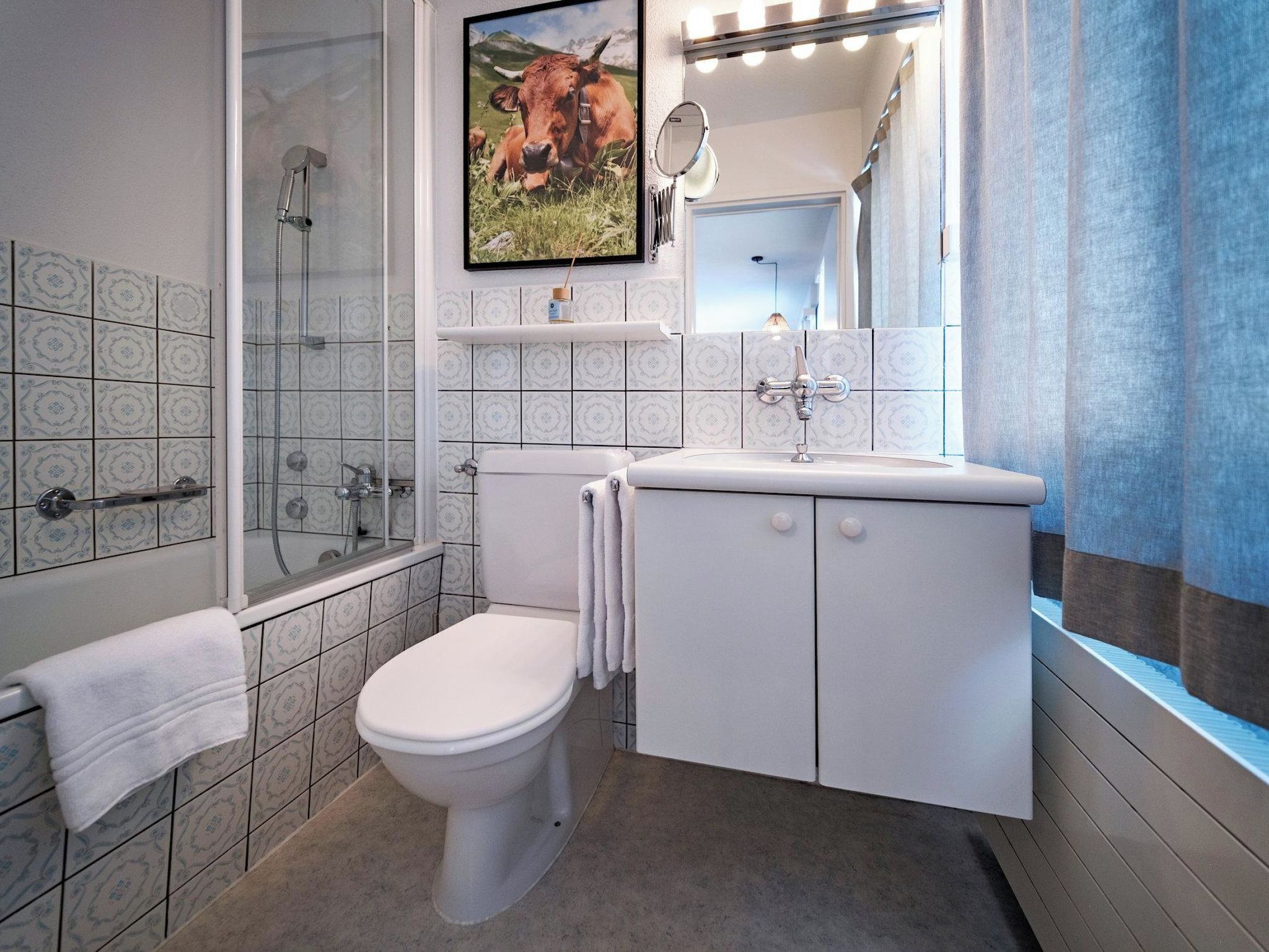 Un baño con inodoro, lavabo y ducha.
