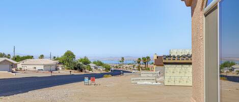 A residential area with houses, a clear sky, and a distant view of mountains.