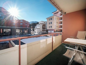 A balcony with a view of a building labeled 'PARADISES' and a mountain in the background. - Paradies 012 Appartement/Fewo,  , 3-Bettwohnung 3-Bettwohnung by Interhome (Arosa)