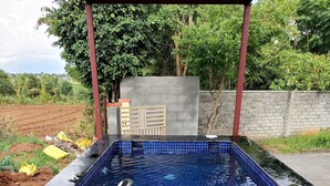 A swimming pool with blue mosaic tiles, metal handrails, and a concrete deck. - Myraa Farms by Stayjade2 Acrepvt Pooljacuzziac (Denkanikota)