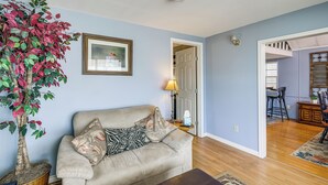 A living room with a beige sofa, a potted plant, a framed picture, and a lamp. - Peaceful, Private Slice of Deep South Texas (San Benito)
