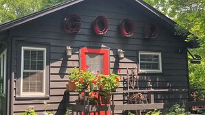 A wooden house with the word "GOOD" painted on the front. - Steps to Beach & Lake Michigan! Family Retreat (Lakeside)