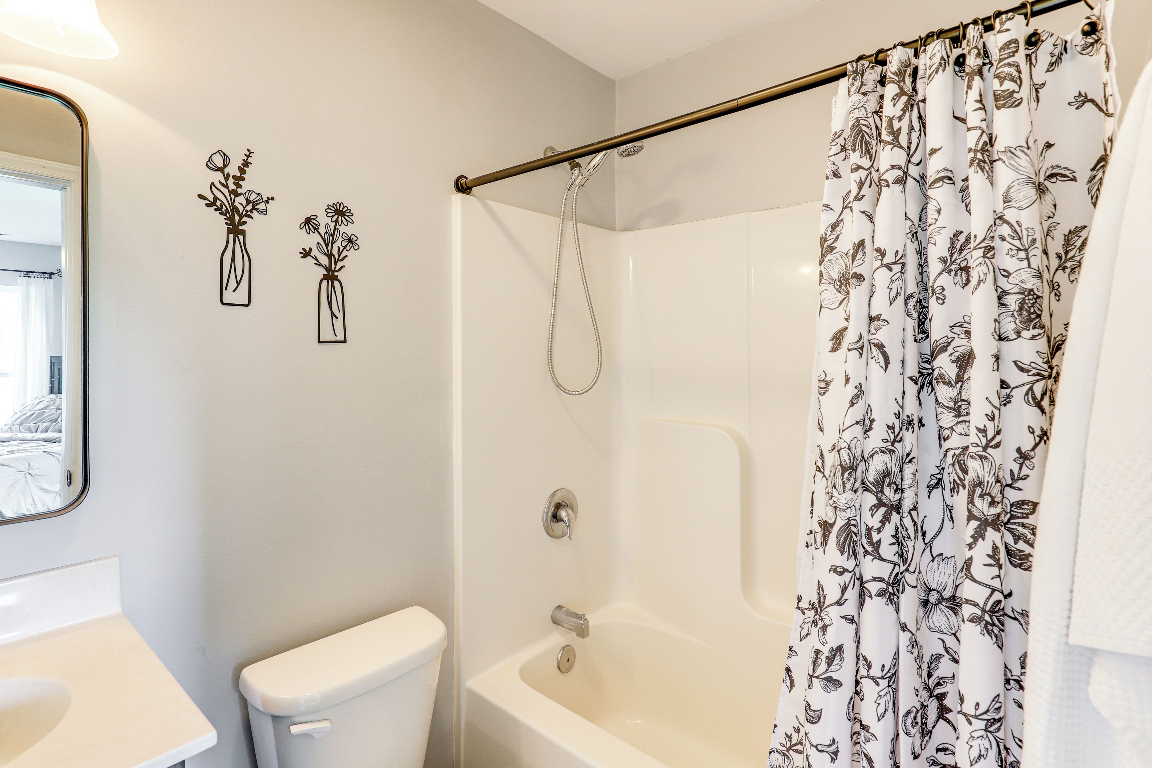 A bathroom with a toilet, sink, shower, and a bathtub.