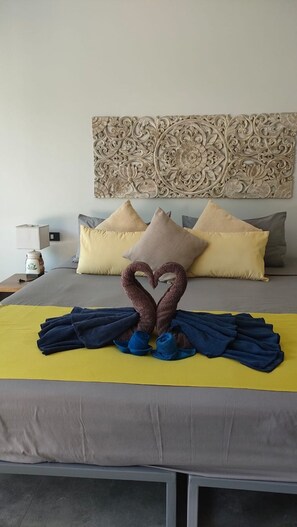 A hotel room with a bed, pillows, a decorative wall piece, and a towel art arrangement. - 4 Bedroom Villa Sawadee 500 metres to beach SDV391 By Samui Dream Villas (Koh Samui)