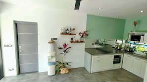 A modern kitchen with white cabinets, a built-in microwave, and a countertop with various appliances. - 4 Bedroom Villa Sawadee 500 metres to beach SDV391 By Samui Dream Villas (Koh Samui)