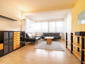 A modern living room with a sofa, a coffee table, and a cabinet. - Haldahus 2 by Arosa Holiday Appartement/Fewo,  , 7-Bettwohnung Haldahus 2 by Interhome (Arosa)