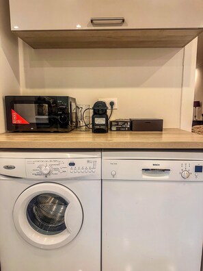 Eine Küche mit Mikrowelle, Kaffeemaschine und Geschirrspüler.