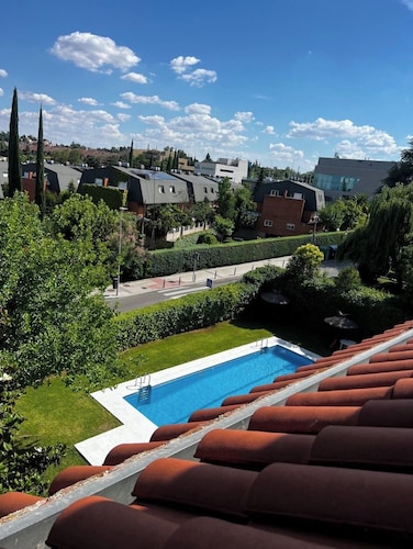 60-square-meter loft-style apartment with a separate kitchen and bathroom, swimming pool, parking, and garden.