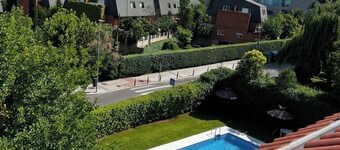 60-square-meter loft-style apartment with a separate kitchen and bathroom, swimming pool, parking, and garden.
