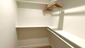 A corner closet with white walls and wooden flooring. - Modern South ATX - 3BR - Fast WiFi - Free Parking (Austin)