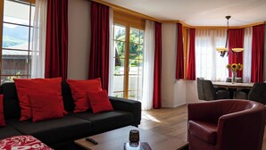 A modern living room with a sofa, armchair, and coffee table. - Valletta Appartement/Fewo, Dusche oder Bad, WC, 6-Bettwohnung by Interhome (Arosa)
