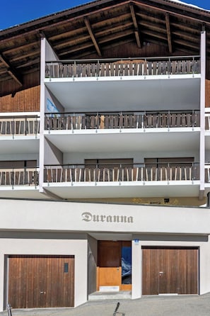 A multi-story building with a wooden facade, balconies, and a sign reading 'Duorma.' - Haus Duranna 7 Appartement/Fewo, Bad, WC, 4-Bettwohnung by Interhome (Arosa)
