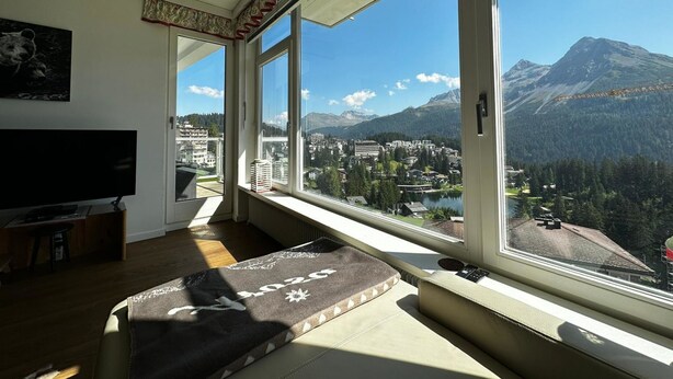 A room with a large window, a television, and a sofa. - Ritschis Home Appartement/Fewo, Dusche, WC, 4-Bettwohnung Ritschis Home by Interhome (Arosa)