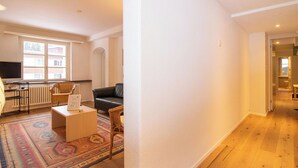 A spacious living area with a sofa, a coffee table, and a patterned rug. - Pradella Garten by Arosa Holiday Appartement/Fewo, Dusche oder Bad, WC, 7-Bettwo by Interhome (Arosa)