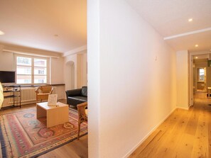 A spacious living area with a sofa, a coffee table, and a patterned rug. - Pradella Garten by Arosa Holiday Appartement/Fewo, Dusche oder Bad, WC, 7-Bettwo by Interhome (Arosa)