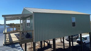 A metal building with a covered porch, a window, and a door.
