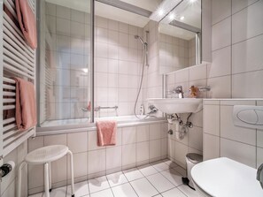 A modern bathroom with a glass shower enclosure, a white sink, and a toilet. - Bristol 41 Appartement/Fewo, Dusche oder Bad, WC, 4-Bettwohnung by Interhome (Arosa)