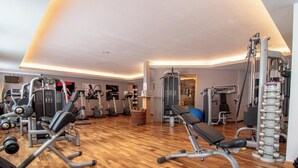 A gym with various exercise equipment, including treadmills, elliptical machines, and weightlifting stations. - Rothornblick 11 by Arosa Holiday Appartement/Fewo, Bad, WC Rothornblick 11 by Interhome (Arosa)