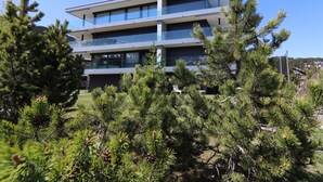A multi-story building with a modern architectural design, featuring balconies and large windows. - Eden 3 by Arosa Holiday Appartement/Fewo, Bad, WC, 6-Bettwohnung by Interhome (Arosa)